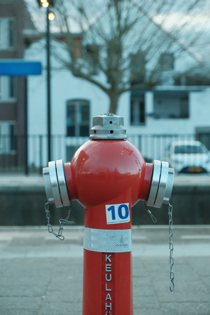 A red fire hydrant with number 10 on an urban street.